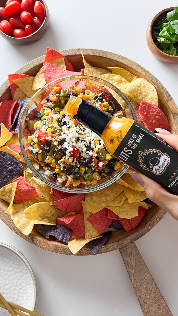 Cowboy caviar dip with LITS Burning Mango hot sauce and tortilla chips