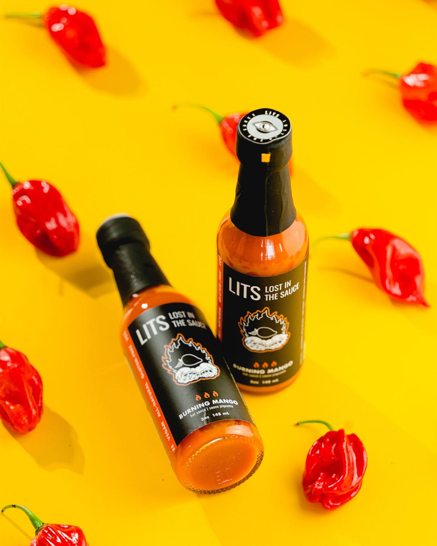 
                  
                    Two Scotch Bonnet Hot Sauce Bottles With Peppers
                  
                
